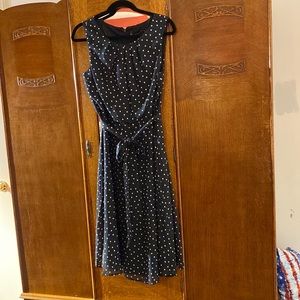 Black w/ white polka dots. The dress is lined.